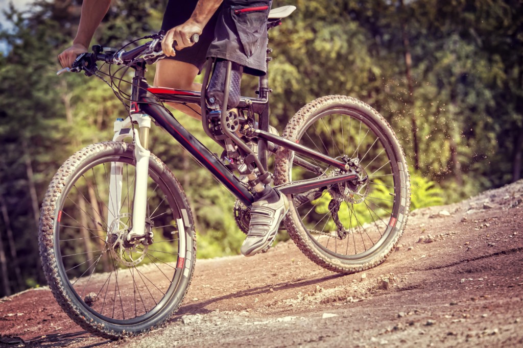 Handicapped mountain bike rider downhill track