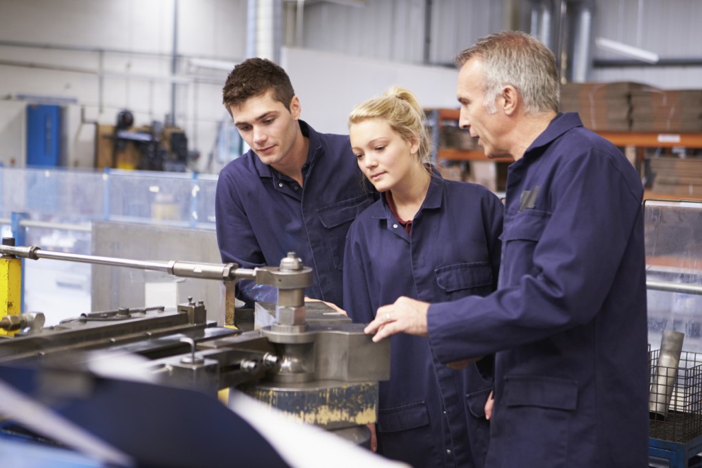 Engineer Teaching Apprentices To Use Tube Bending Machine