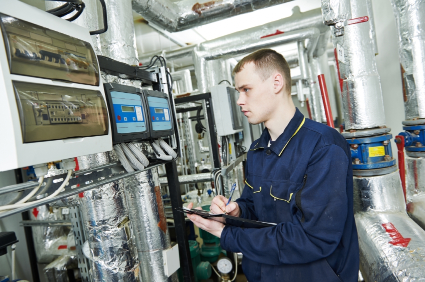 heating engineer repairman in boiler room