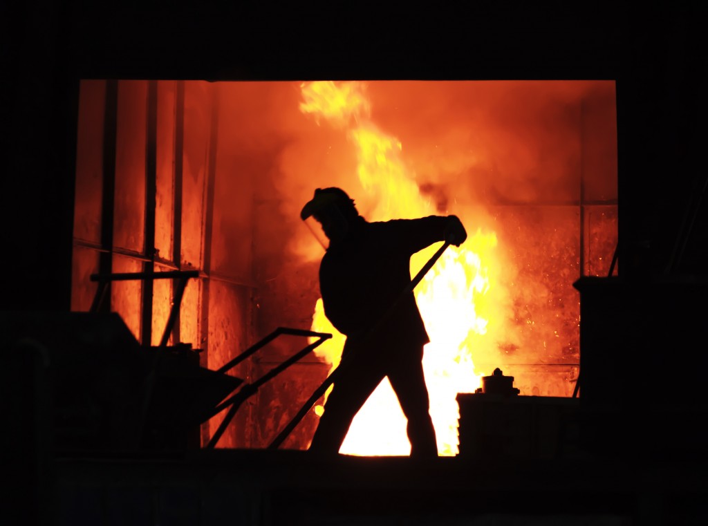 Man is working in the splashing molten iron