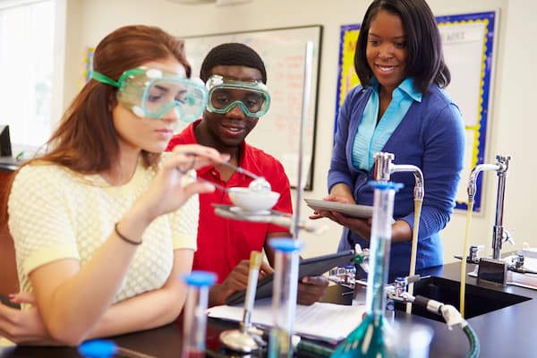 children and teacher in science lesson