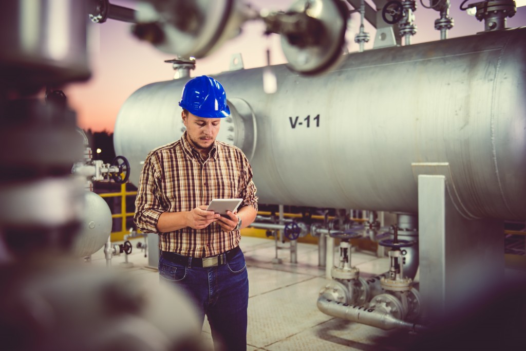 Man using tablet at Natural gas processing facility