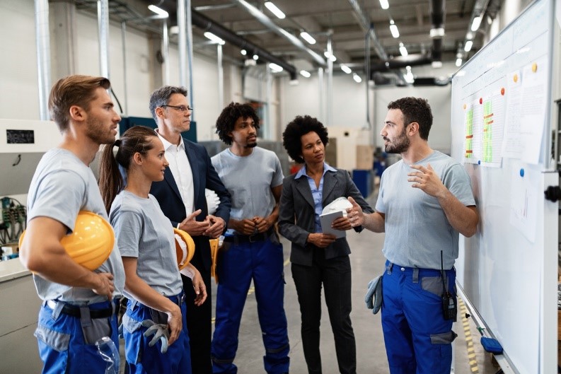 Young engineering apprentices attending an open day in a factory