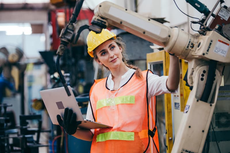 Young female engineer studying machinery