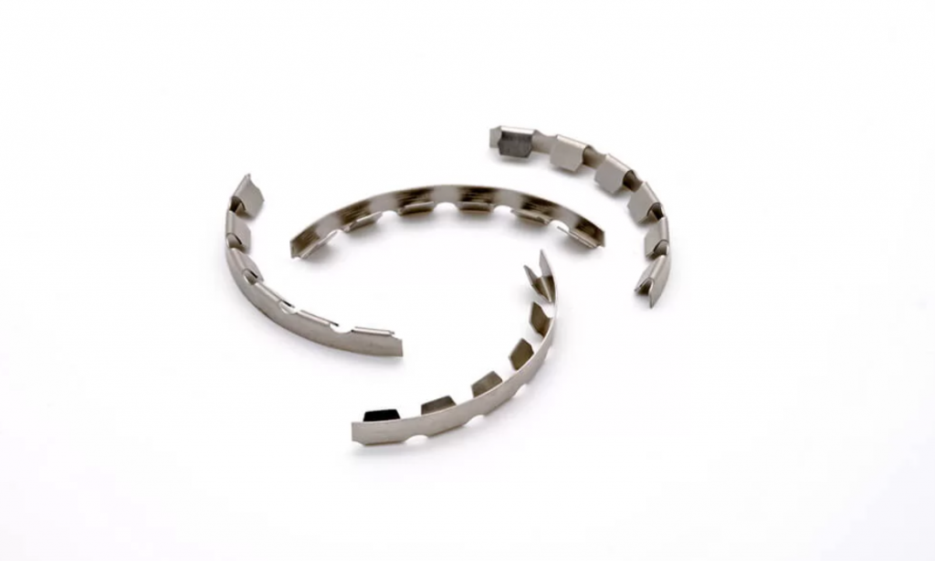 Four curved metal components