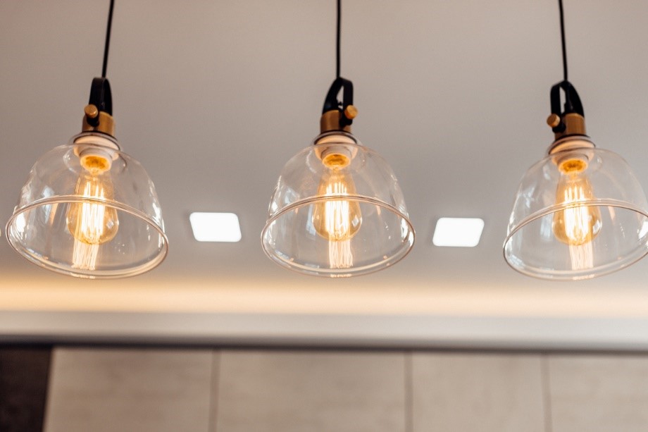 Three light fittings hanging from a ceiling