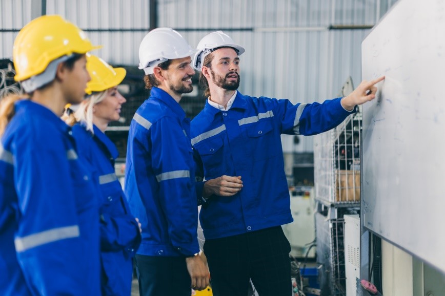 Apprentices looking at a whiteboard