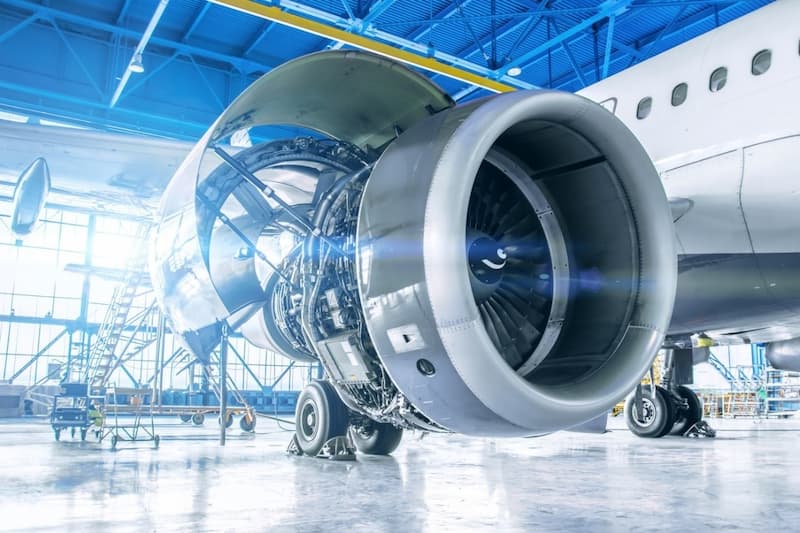 A large jet engine in a hangar