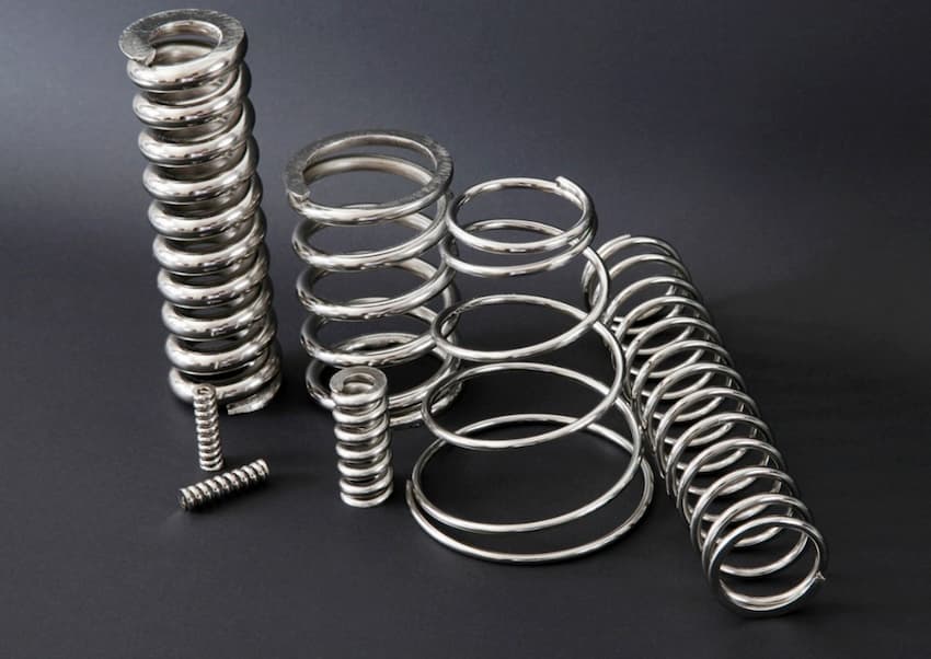 Several metal springs on a black surface