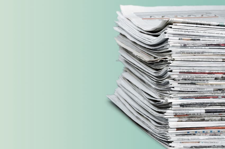 A stack of newspapers on a table