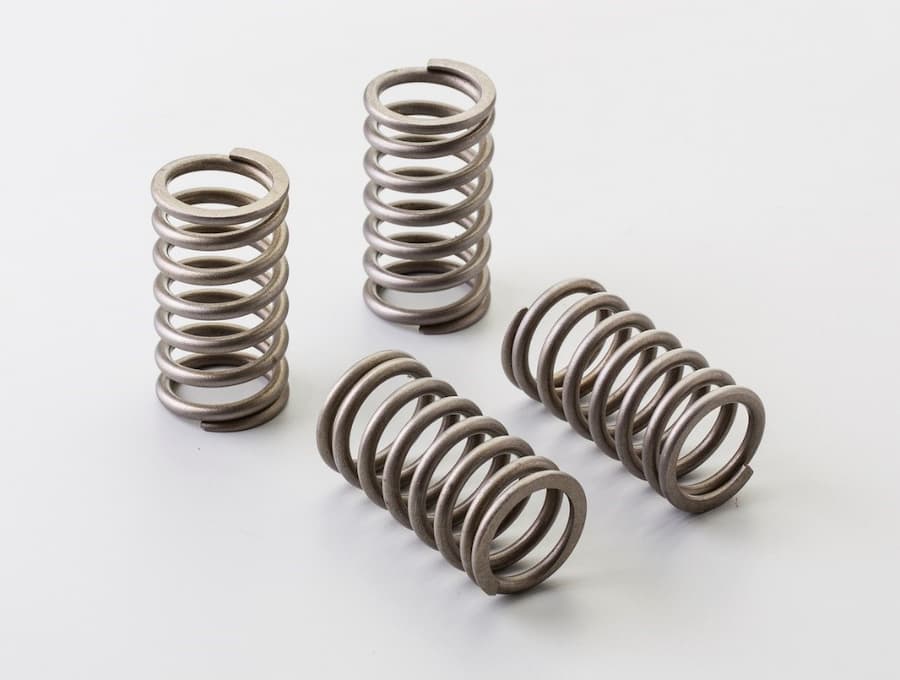 Several metal springs on a white surface