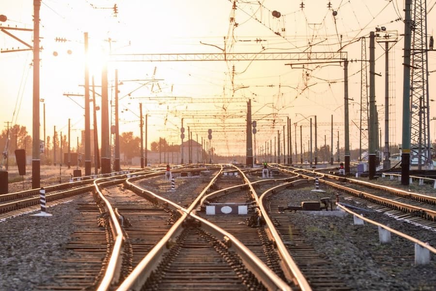 A train tracks with power lines above