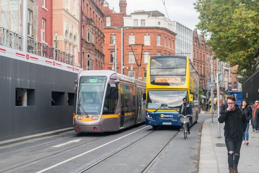 A two buses on a street